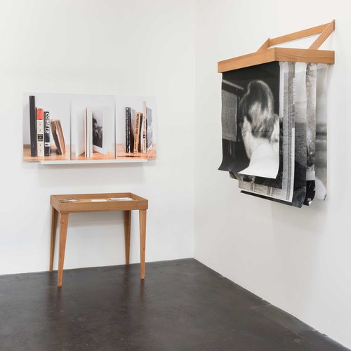 Photography installation with books, notepad and table.