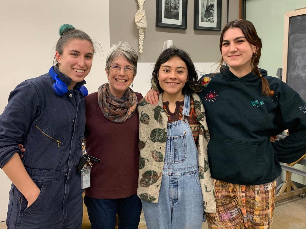 A group of four poses for a picture.