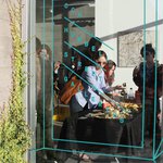 view of opening art reception through window at Hubbell St Galleries