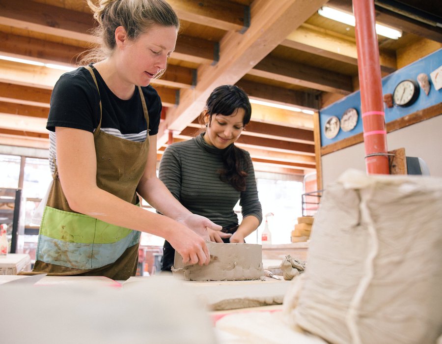 CCA Ceramics professor Kari Marboe helps a student structure their clay work.