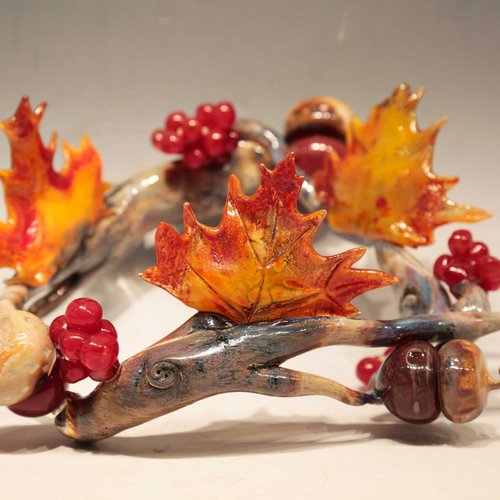 Crown of leaves, branches and fruits in cast glass by Kelsey Kenney.