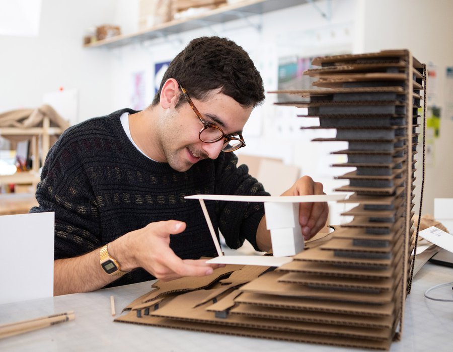 An architecture student works on his model for an upcoming review.