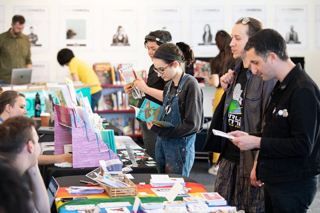 Students look at comics during an MFA comics pop up fest on campus.
