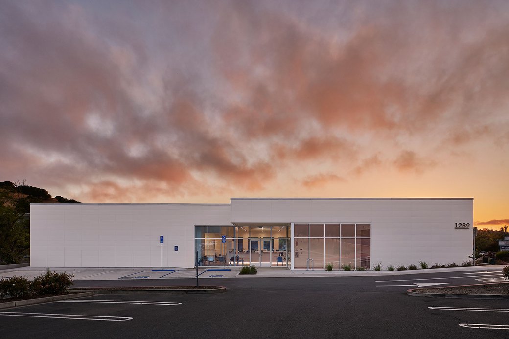 East Bay Ophthalmology Office set against an orange-to-purple gradient sky.