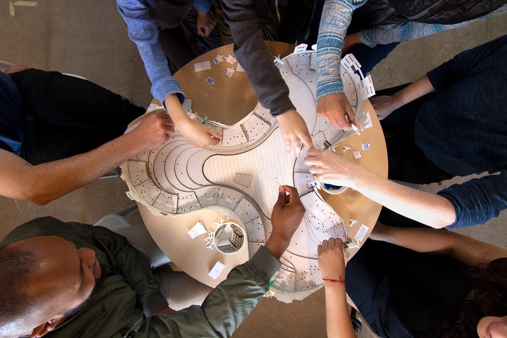 Students working together on an architecture building project.