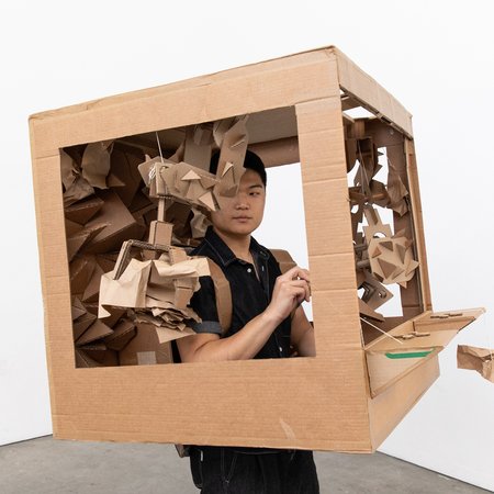 A first year student enclosed in their cardboard box for the Putting on Protest class.