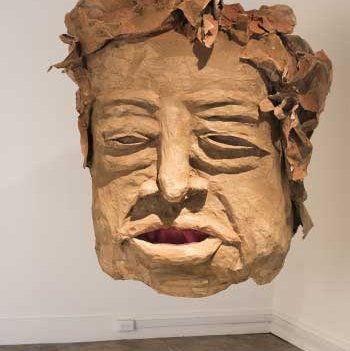 Giant head made from papier-mâché and mixed media.