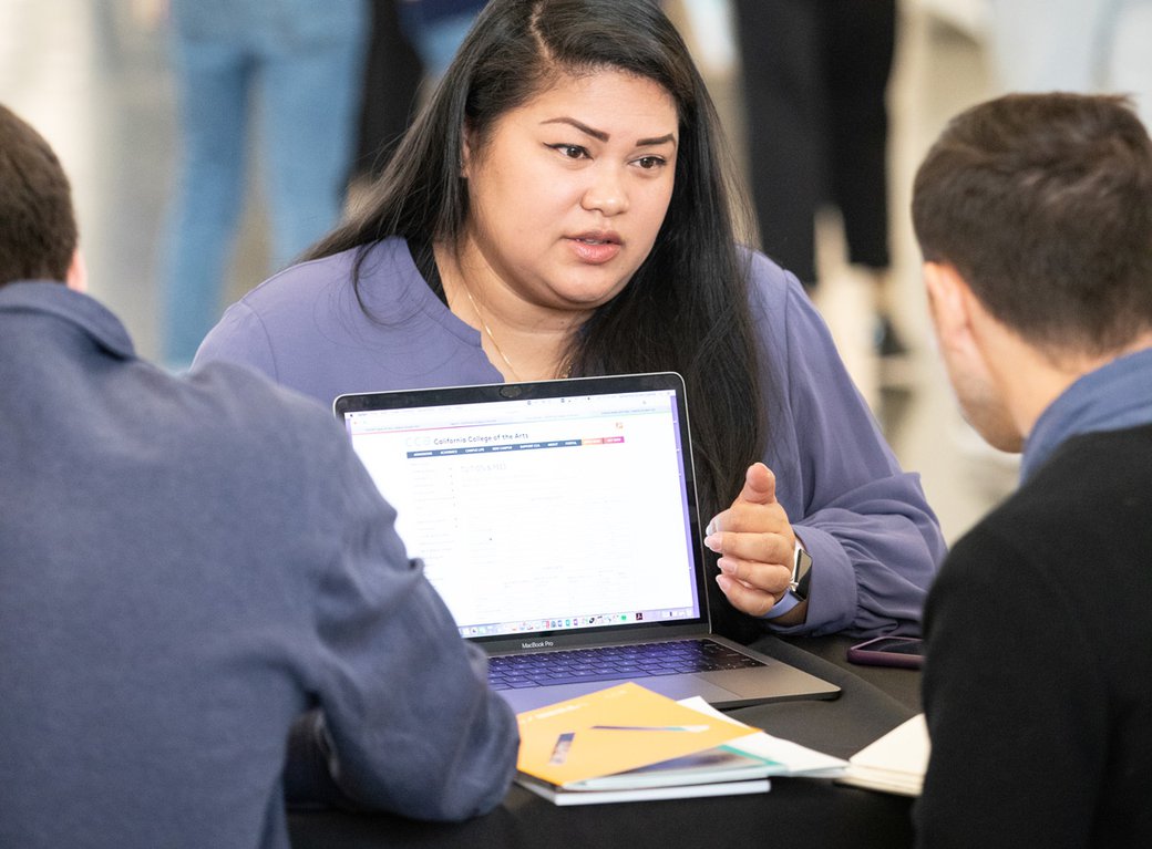 Admissions associate helping potential students learn about the program.