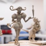 Sculpted figurines resembling whimsical versions of medieval characters with one holding a dagger upside down.