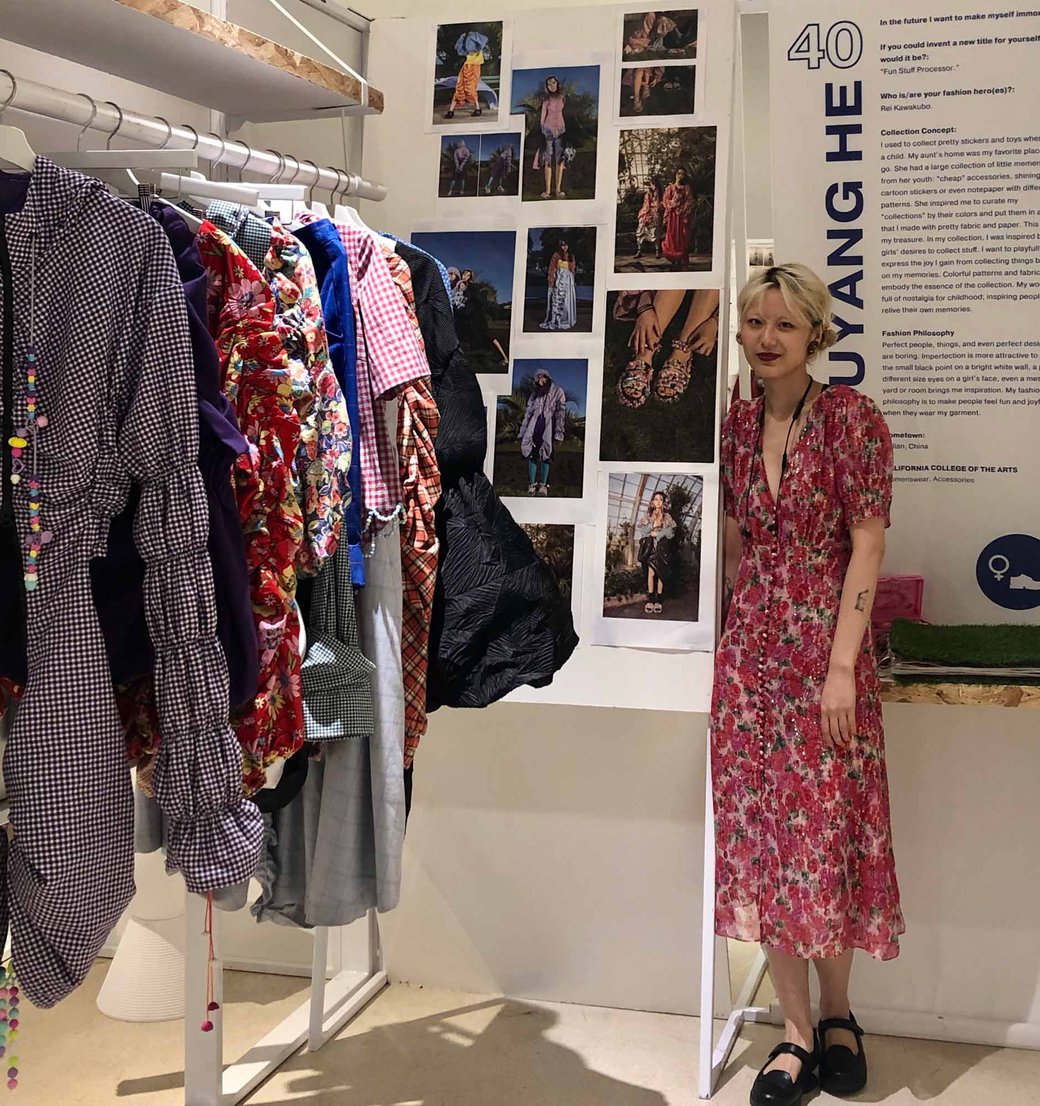 CCA Fashion Design student Clair posing next to their work.