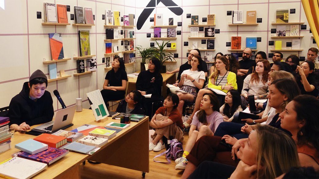 Graphic designer and curator Na Kim speaks to a group at the Curatorial Research Bureau in San Francisco.