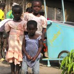 Children standing in front of a Juabar charging station