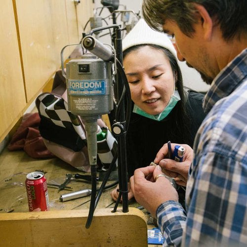 Metalworking student gets help from faculty.