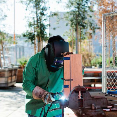 Student welding in the metal welding studio.