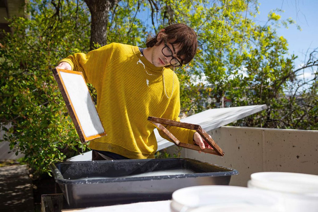 student making paper by hand