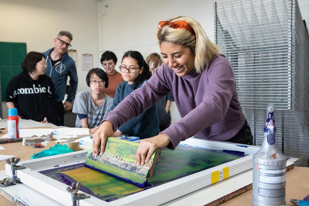 student learning how to screenprint