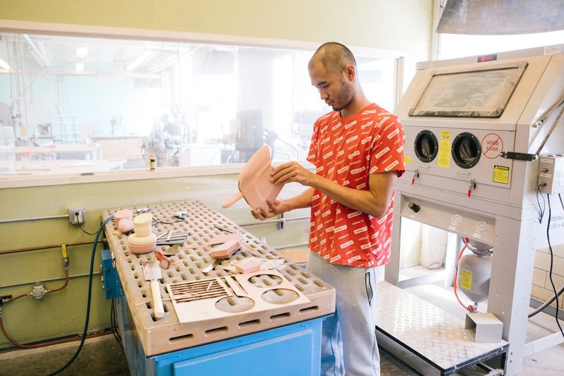 A student sands and refines their prototypes in the Model Shop.