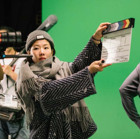 BFA Film student shooting takes in the green screen film cage