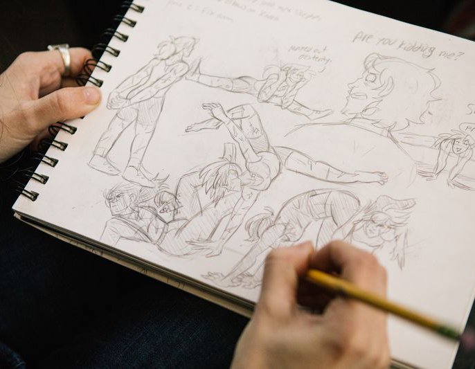Student working on animation sketches during class