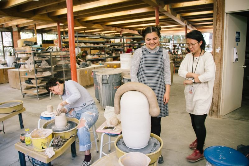BFA Ceramics professor Cathy Lu consults student on their large scale ceramic sculpture